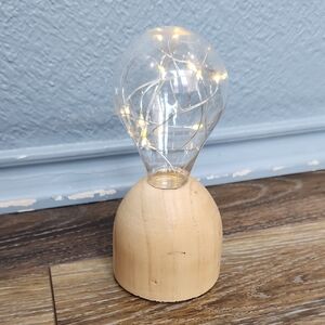 Plastic Lightbulb Shape on Wood Stand